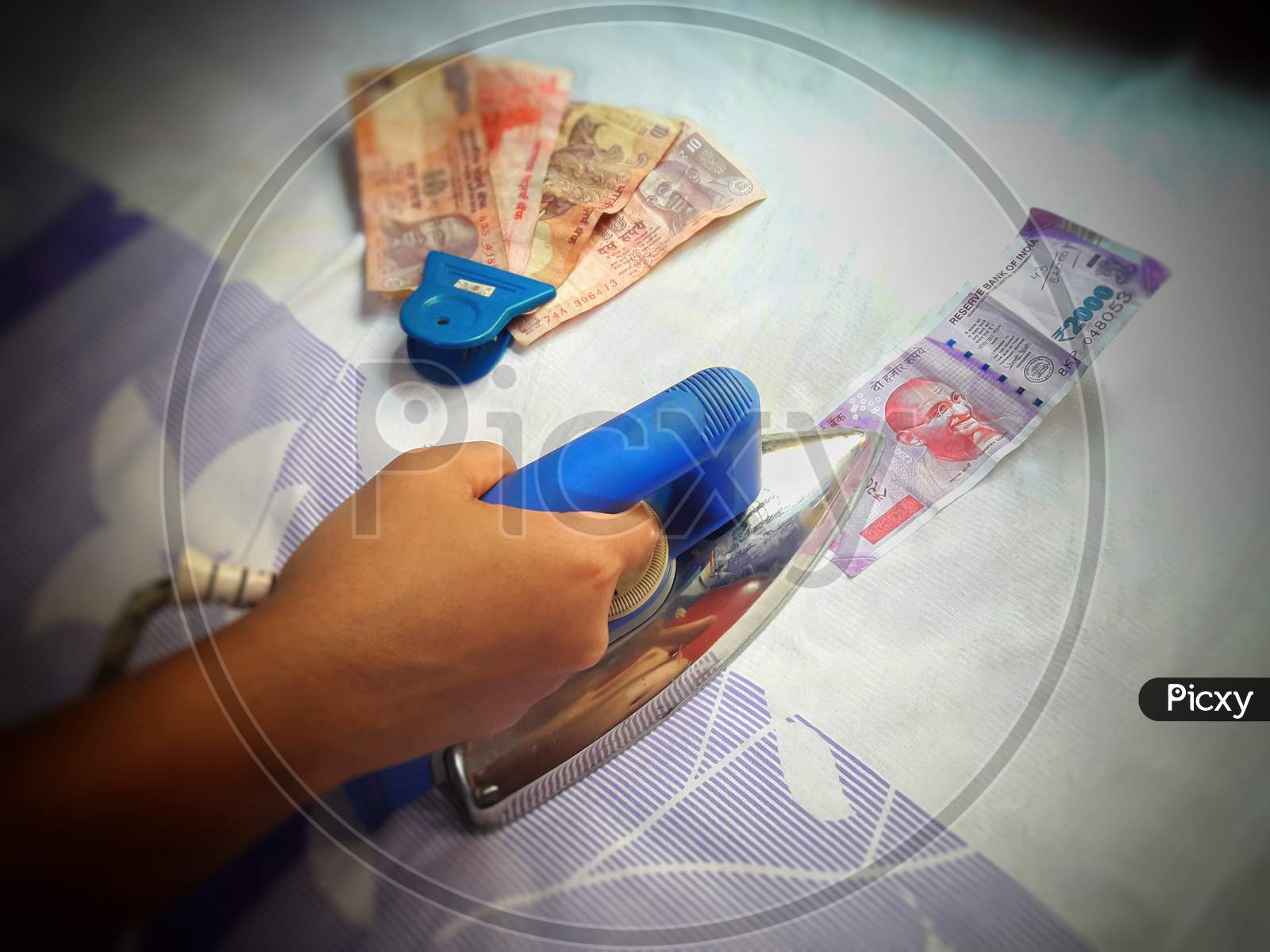 Sanitization of indian currency note by pressing hot iron to avoid contamination from covid 19