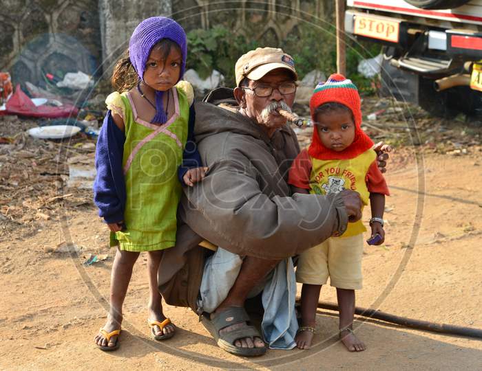An Elderly Poor man With His Grand Children In an Village