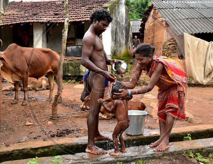 Tribal Poor Family Bathing Openly On Tribal Village Streets