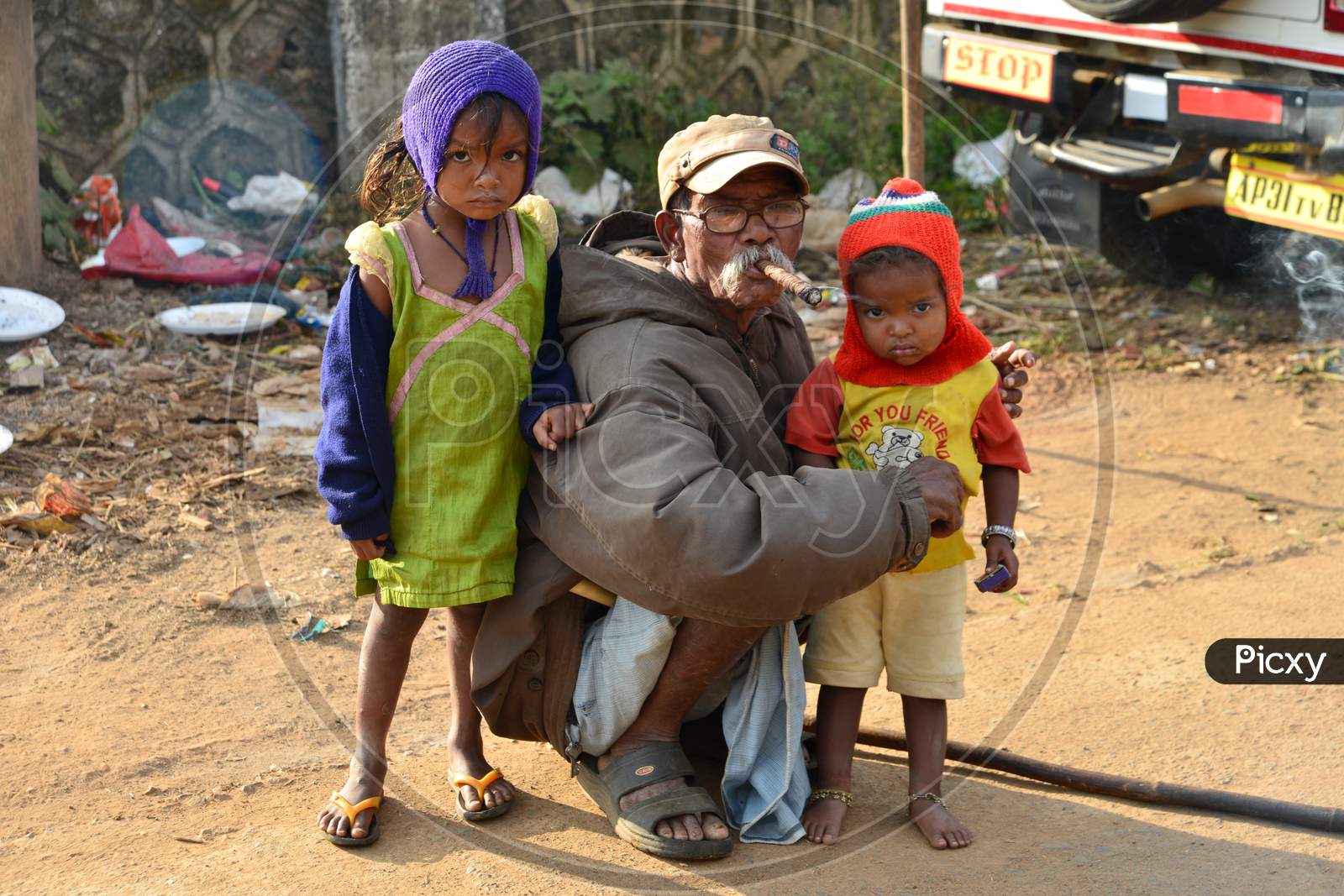 An Elderly Poor man With His Grand Children In an Village