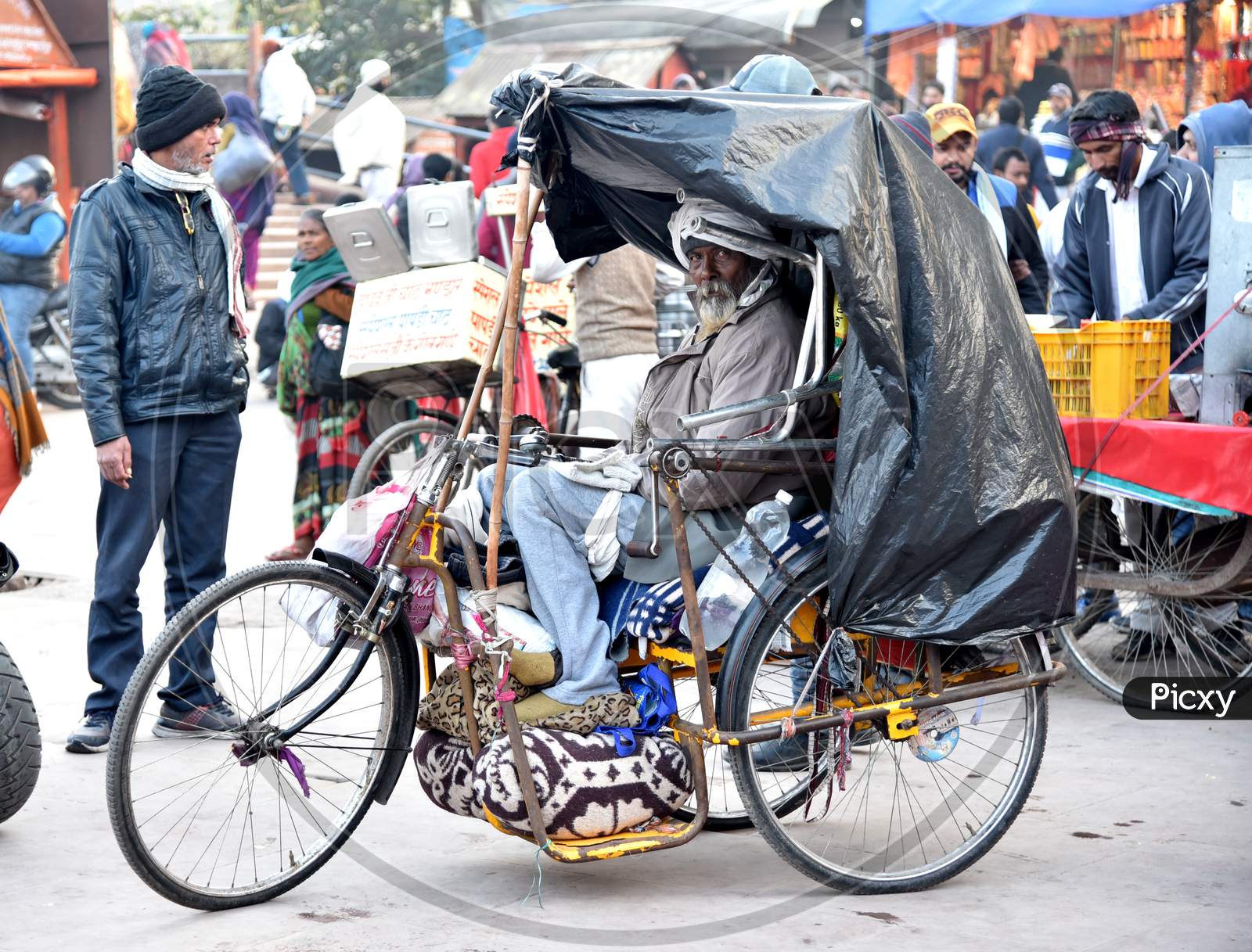 A Poor Man Or Physically Handicapped Man On an Tricycle And Begging