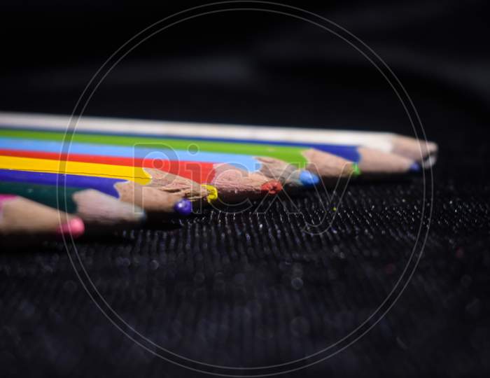 color pencils in a black floor