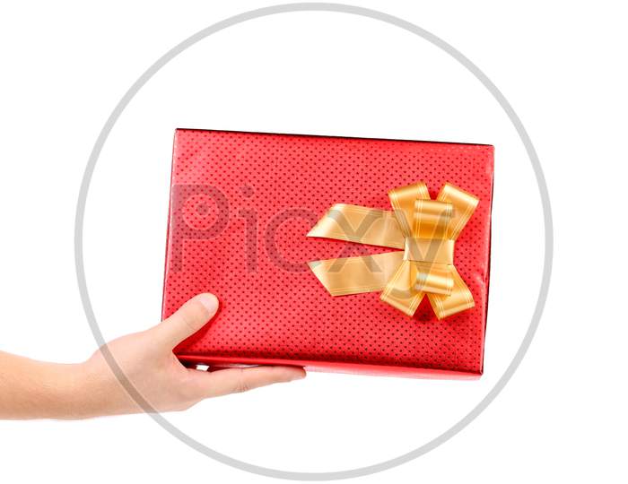 Hand Holds Red Box With Gold Bow. Isolated On A White Background.