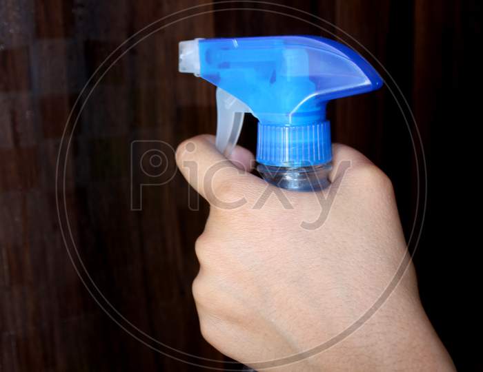 hand holding cleaning sanitizer spray