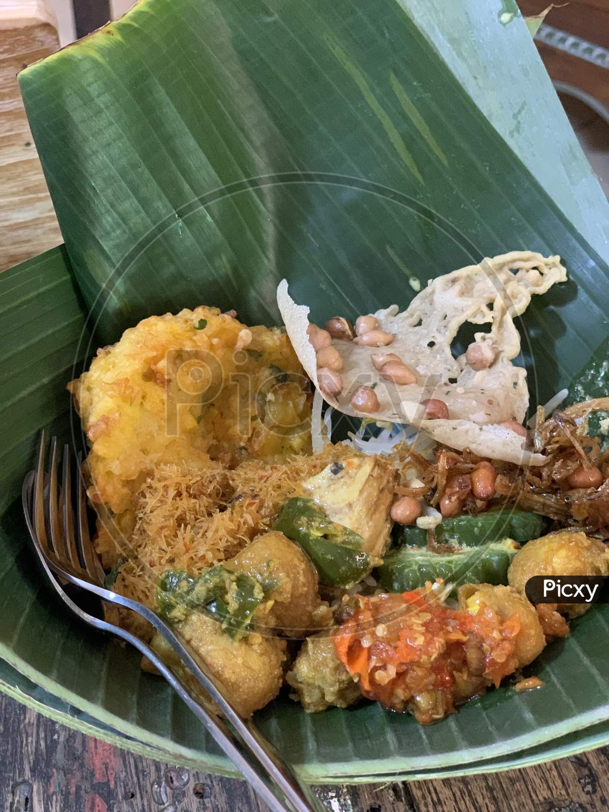 Traditional spicy rice bowl, using banana leaf "nasi pincuk" original from central Java