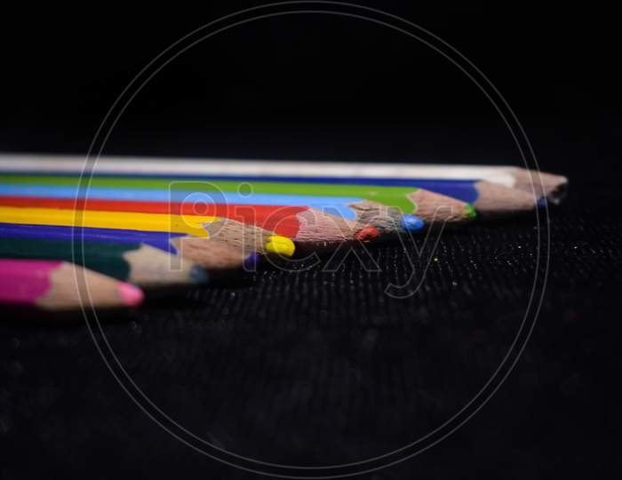 color pencils in a black floor