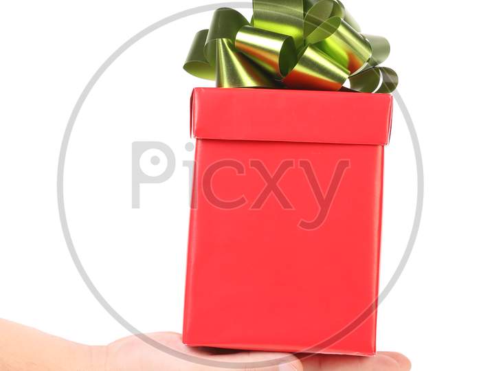 Hand Holds Red Box With Bow. Isolated On A White Background.
