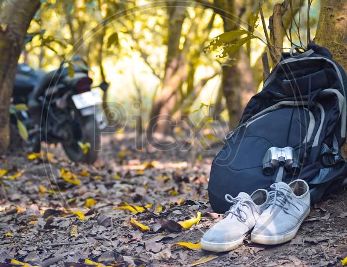 Hiking boots and bag in the forest