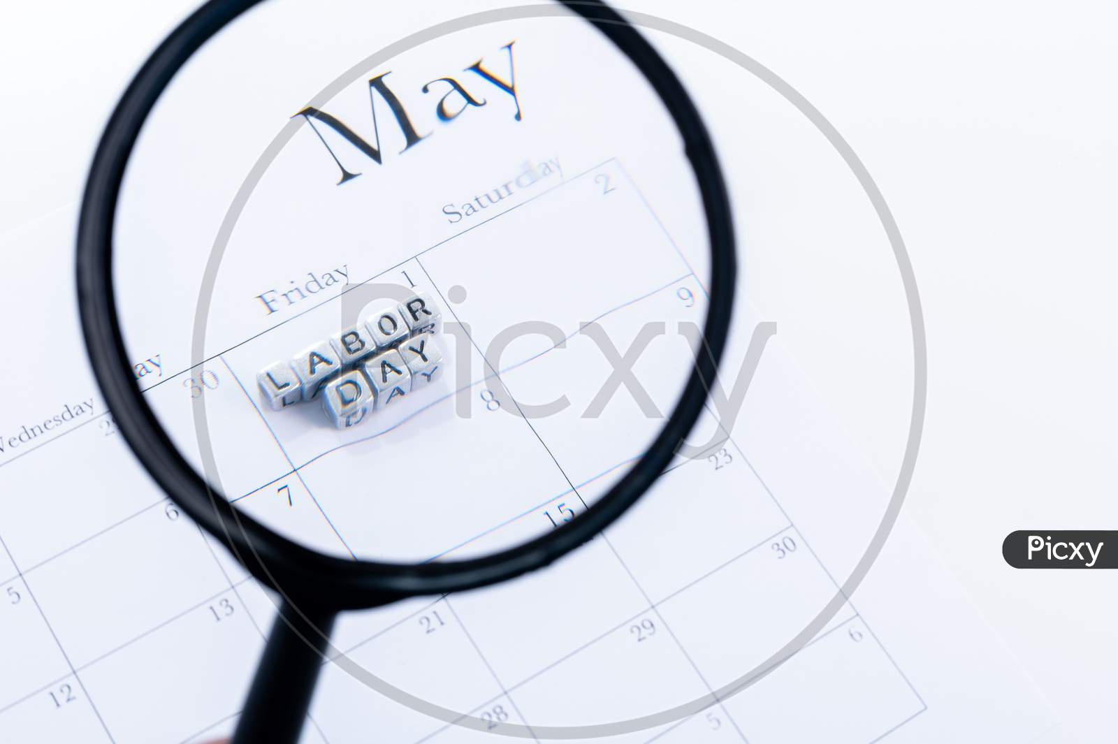 Concept Image Of A Calendar With A Silver Cube Word. Closeup Shot With Magnifying Glass. The Words "Labor Day" On Isolated, Copy Space
