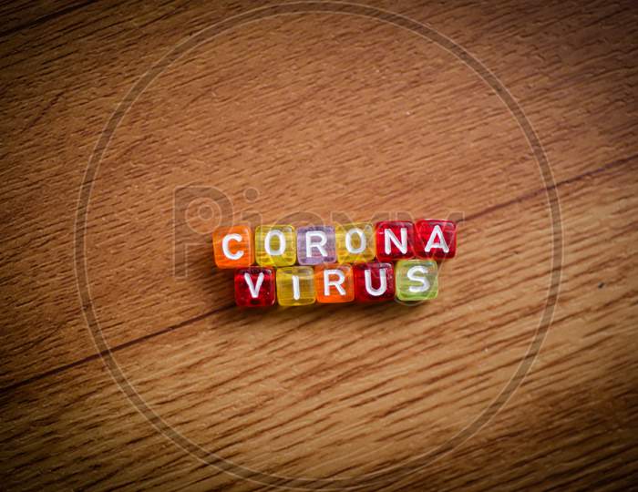 Colorful Word Corona Virus English Alphabet Cube On Brown Color Background , Selective Focus