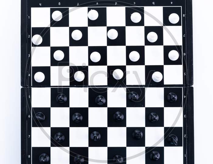 Symbol Of Competition. Chess Board And Chess Figures On White Background Top View Copy Space