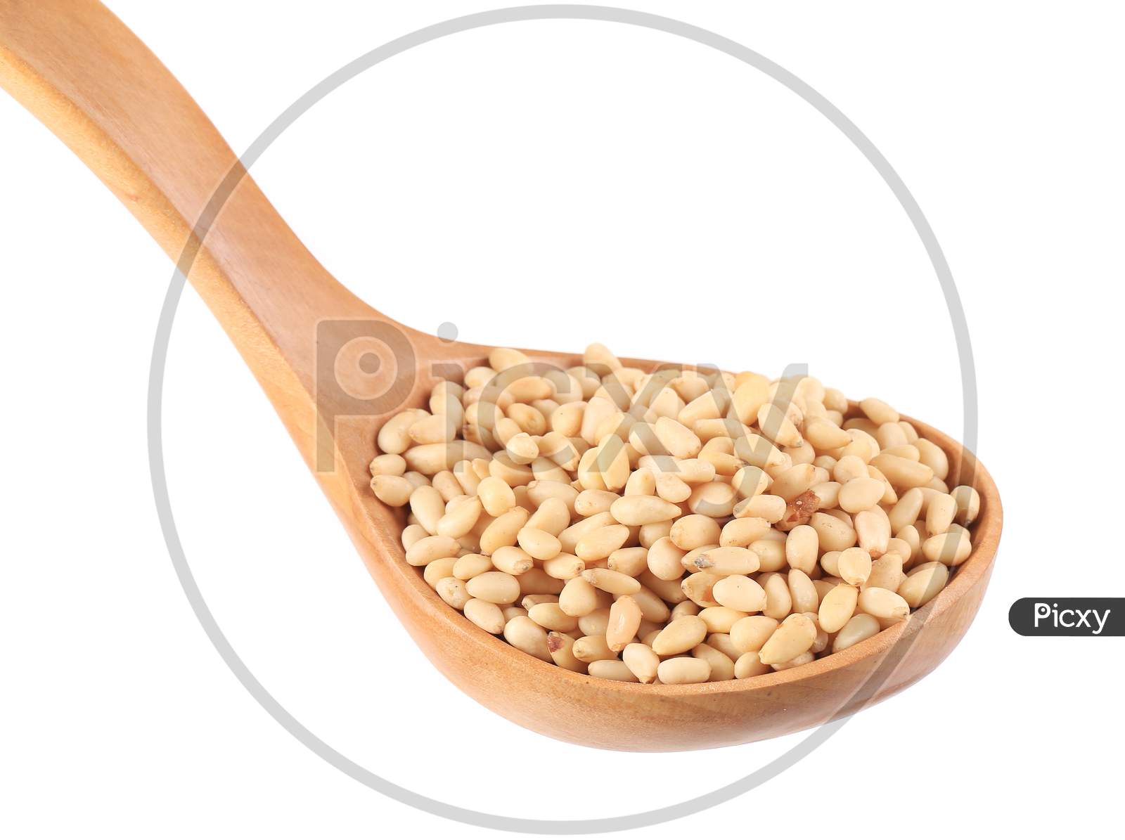 Wooden Spoon Full With Pine Nuts. Isolated On A White Background.