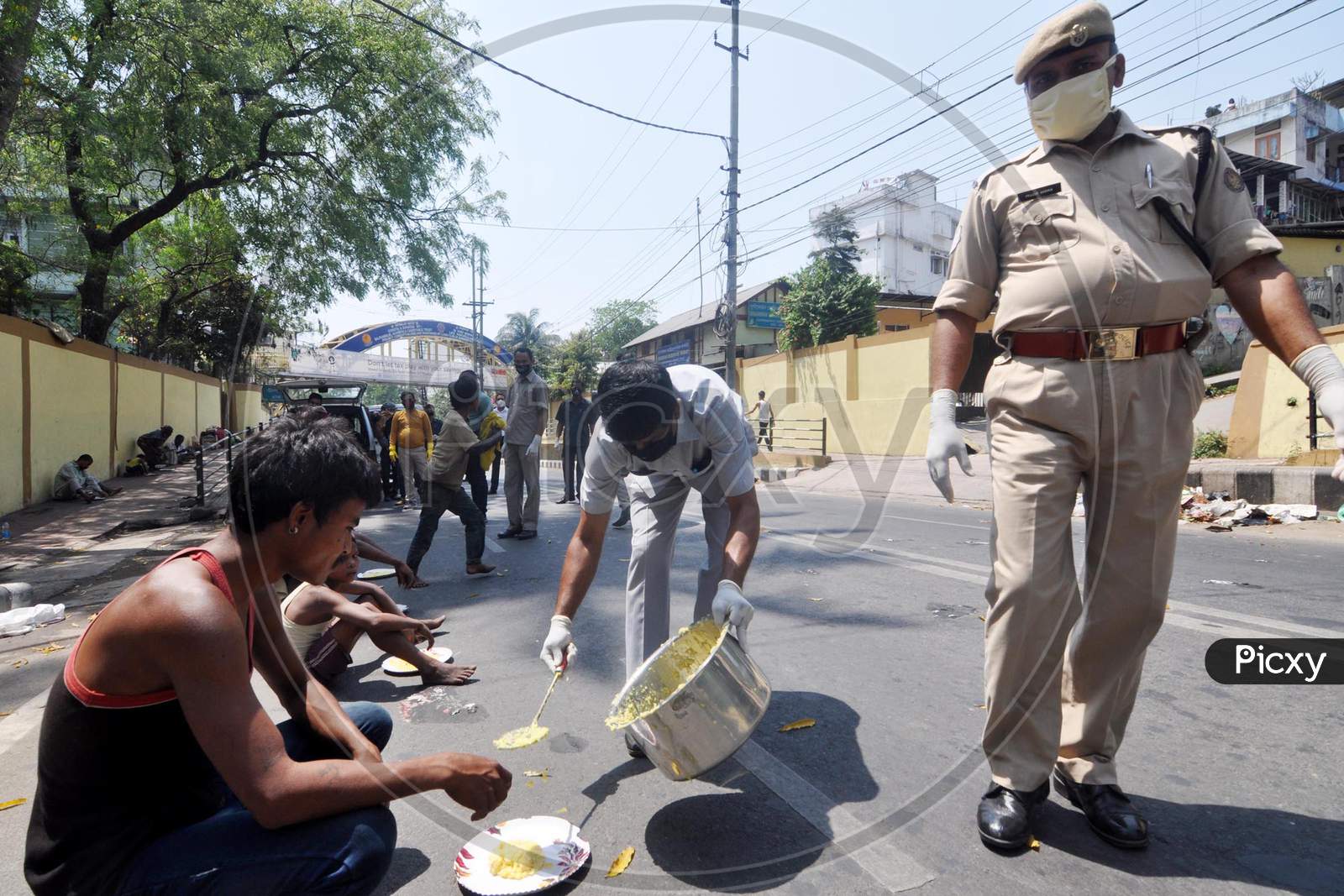 Assam Police Personnel Distributing Rice To The Poor During  The Nationwide Lockdown To Curb The Spread Of Coronavirus, In Guwahati, Sunday, April 5, 2020.