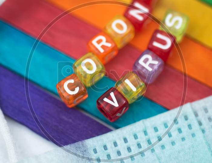 Colorful Word Corona Virus English Alphabet Cube On Colourfull Background And Face Mask, Selective Focus