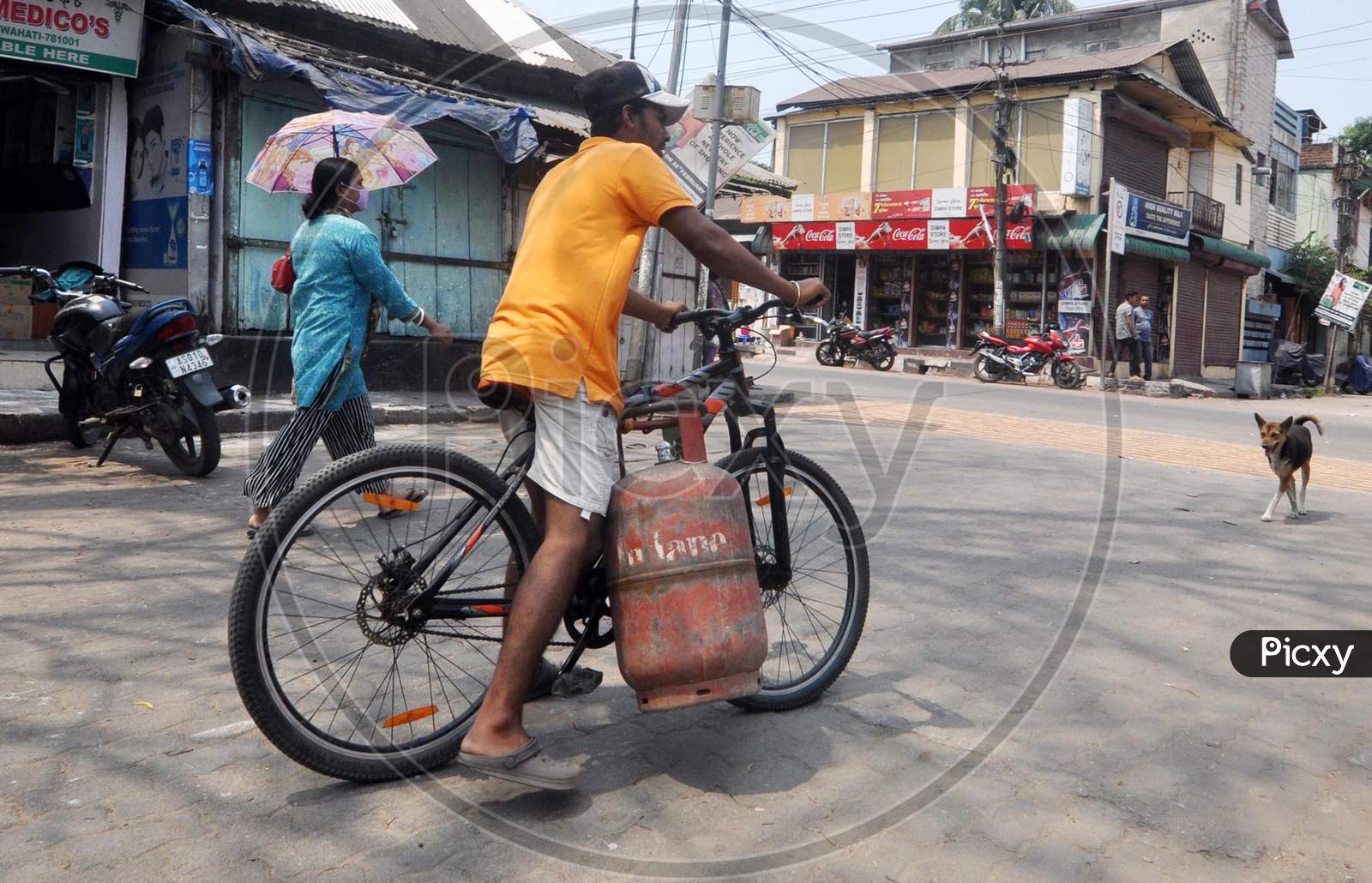 People Carry An Lpg Cylinder During 4 Day Of Complete Lockdown In The Wake Of The Corona Virus Pandemic In Guwahati On Saturday, 28 March 2020.