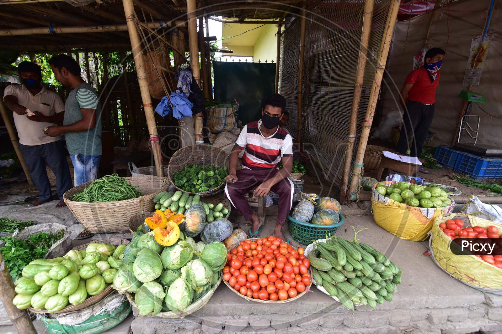 Vendors Wears  Mask As They Wait For Customer At A  Vegetables Market  On The Third  Day Of National Lockdown Imposed By Pm Narendra Modi To Curb The Spread Of Coronavirus In Nagaon District Of Assam,India
