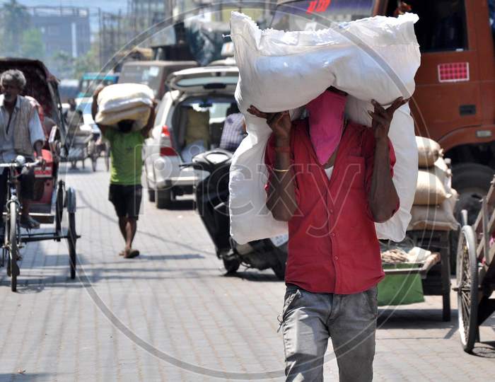 An Indian Labour Carry Sack Of Food Grain At Whole Sale Market  During Nationwide Lockdown, As A Preventive Measure Against The Covid-19 Coronavirus, In  Guwahati ,India