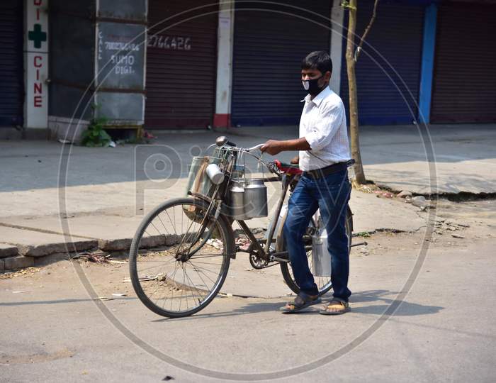 A Milkman  Push A Bicycle   During A Nationwide Lockdown In The Wake Of Coronavirus Pandemic, In Nagaon District Of Assam ,India