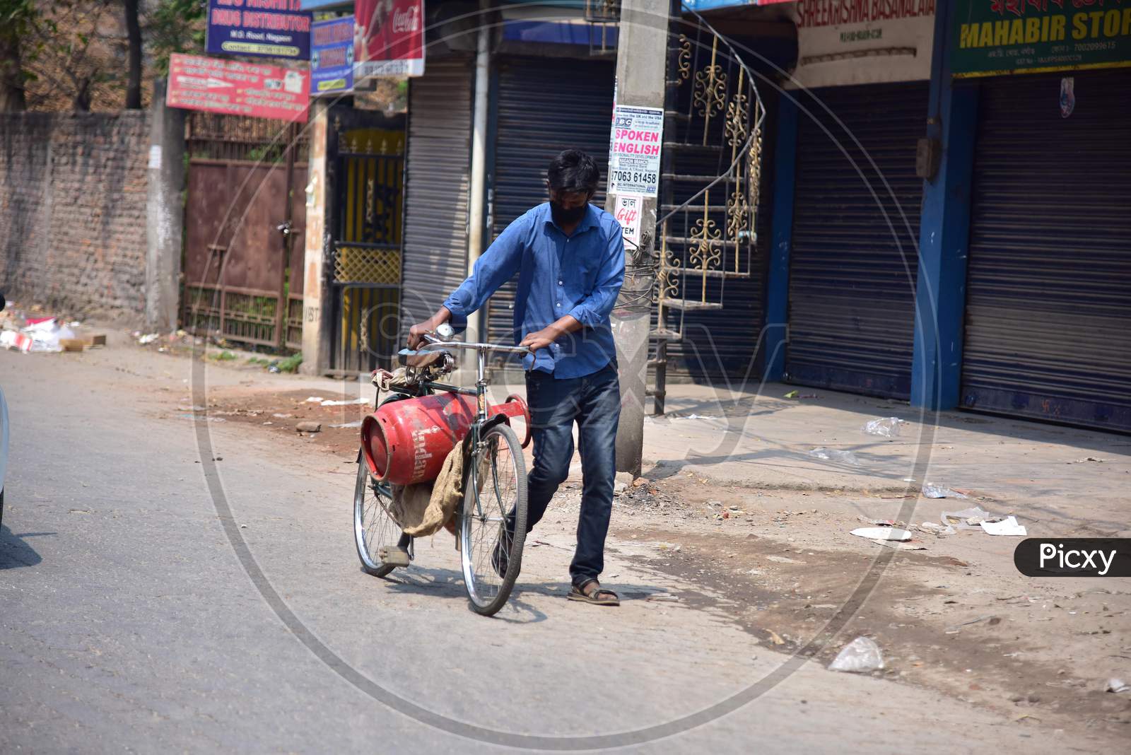 A   Commuter Carry A  L.P.G Cylender On His Bicycle  During A Nationwide Lockdown In The Wake Of Coronavirus Pandemic, In Nagaon District Of Assam ,India