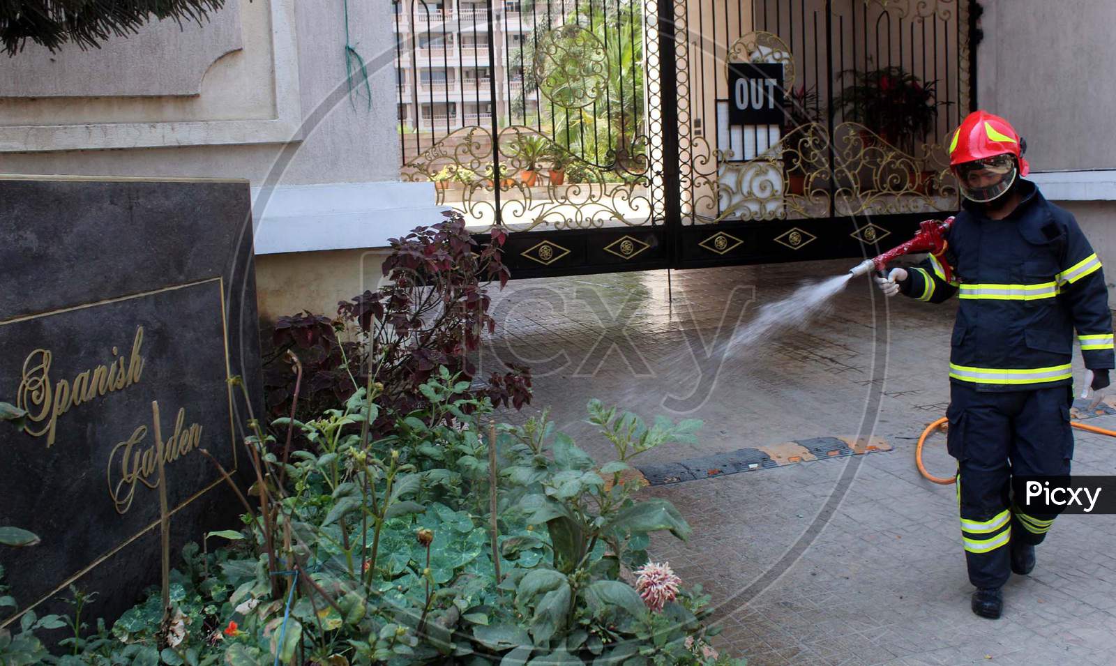 Firefighters Spray Disinfectantsthe Main Entrance Of A Residential Complex (Spanish Garden) During A Nationwide Lockdown In The Wake Of Coronavirus Outbreak, In Guwahati, Saturday, April 4, 2020. Reportedly, One Person Living In The Complex Tested Postive For Covid-19.