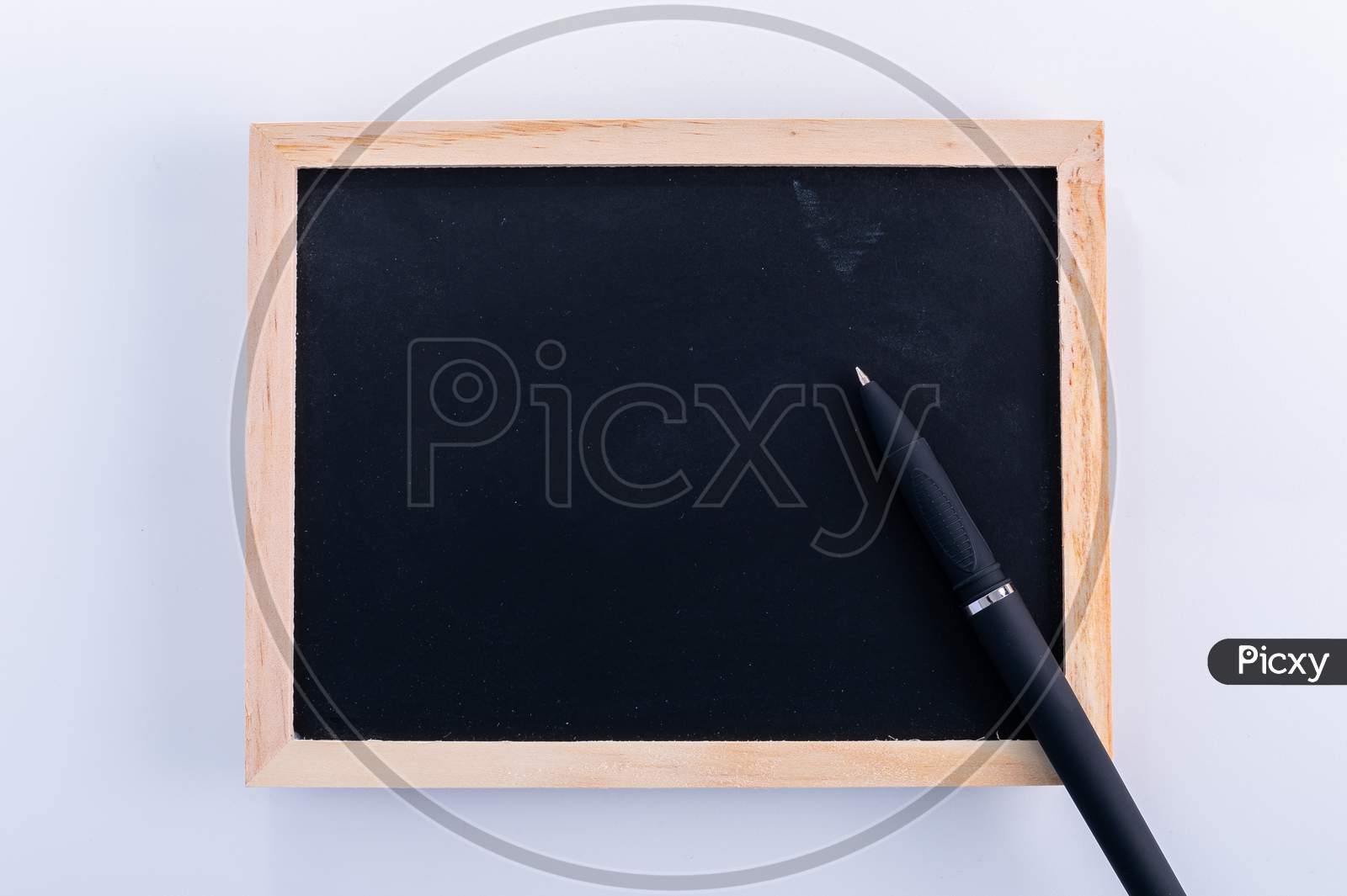 Blackboard With Pen On White Background