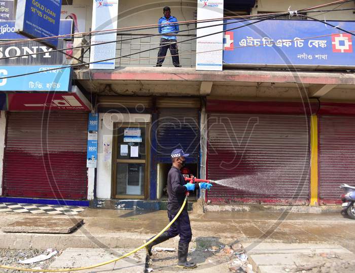 Firefighter Sprays Disinfectants As A Preventive Measure Against The Spread Of The New Coronavirus On A Market In Nagaon District Of Assam On March 31,2020