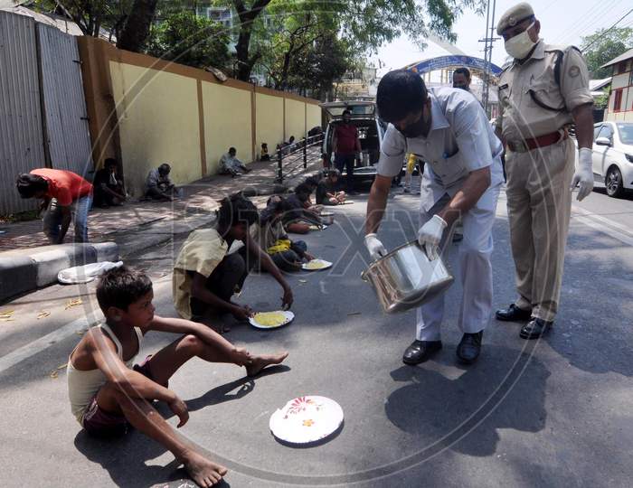 Assam Police Personnel Distributing Rice To The Poor During  The Nationwide Lockdown To Curb The Spread Of Coronavirus, In Guwahati, Sunday, April 5, 2020.