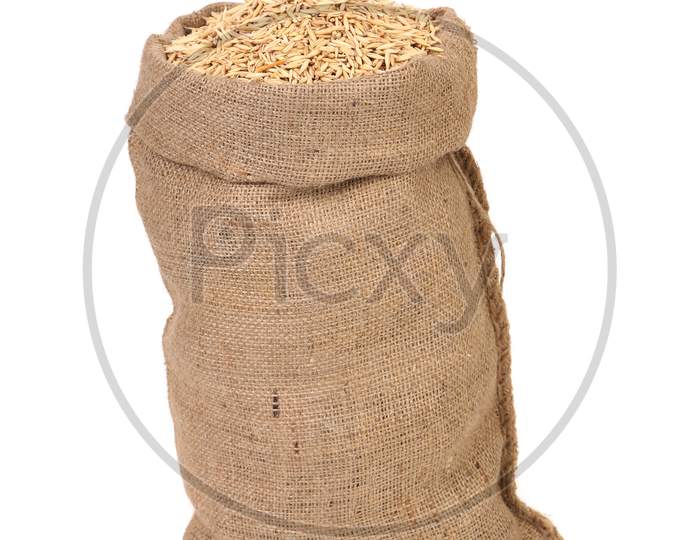 Wheat Grains In The Bag. Isolated On A White Background.