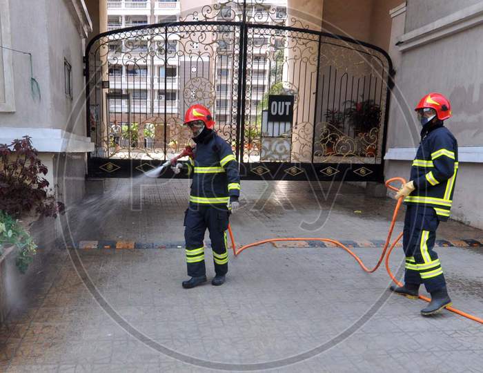 Firefighters Spray Disinfectantsthe Main Entrance Of A Residential Complex (Spanish Garden) During A Nationwide Lockdown In The Wake Of Coronavirus Outbreak, In Guwahati, Saturday, April 4, 2020. Reportedly, One Person Living In The Complex Tested Postive For Covid-19.