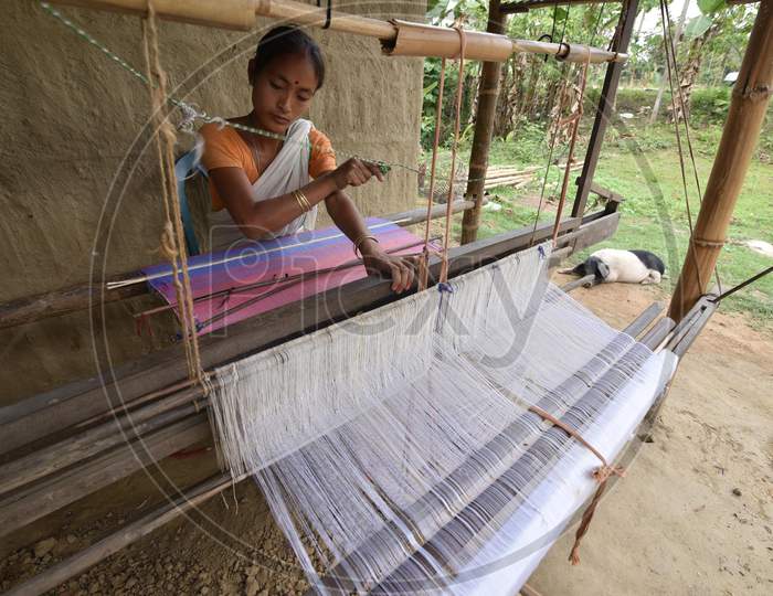 Assamese woman weaves cloth on a loom ahead of Rongali Bihu festival in the Morigaon district, in the northeastern state of Assam