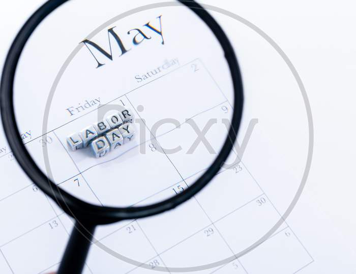 Concept Image Of A Calendar With A Silver Cube Word. Closeup Shot With Magnifying Glass. The Words "Labor Day" On Isolated, Copy Space