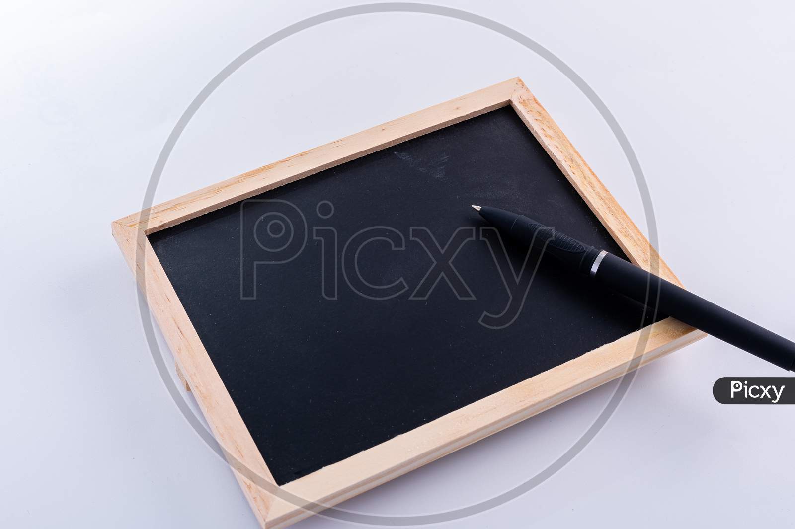 Blackboard With Pen On White Background