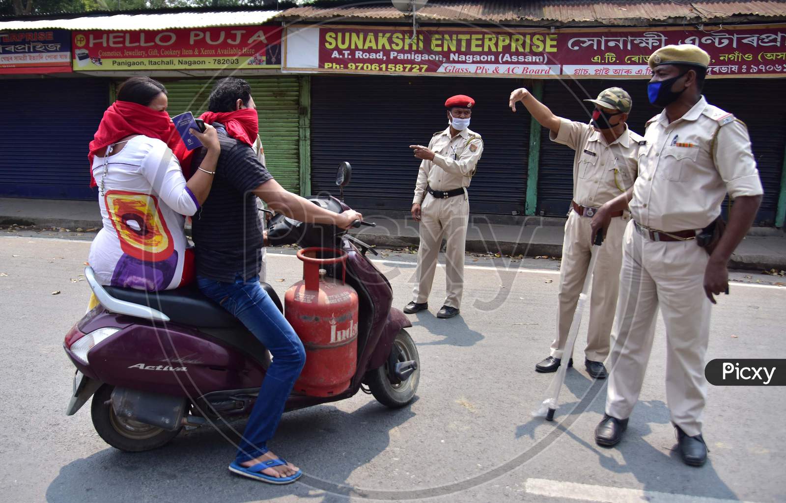 Police Personnel Question Commuters Who Defied Curfew During A 21-Day Nationwide Lockdown, In The Wake Of Coronavirus Pandemic, In Nagaon District Of Assam On Mar 26,2020.