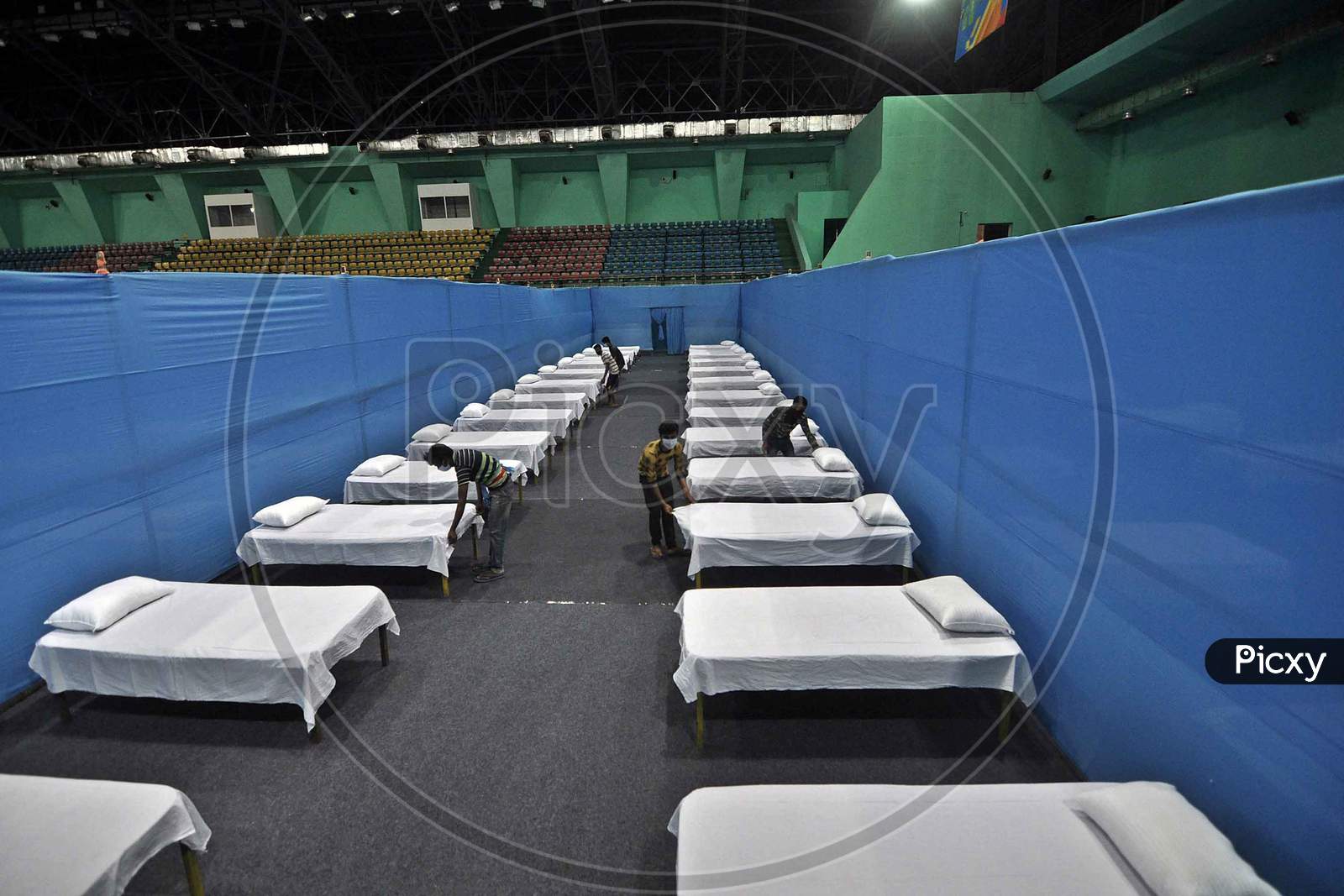 A Worker Arranges Beds To Prepare A Quarantine Centre In An Indoor Stadium At The Sarusajai Sports Complex During A Government-Imposed Nationwide Lockdown As A Preventive Measure Against The Covid-19 Coronavirus In Guwahati,India