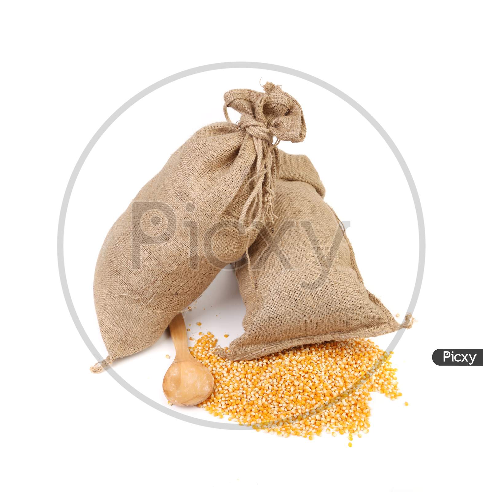Two Sacks With Corn Grains. Isolated On A White Background.
