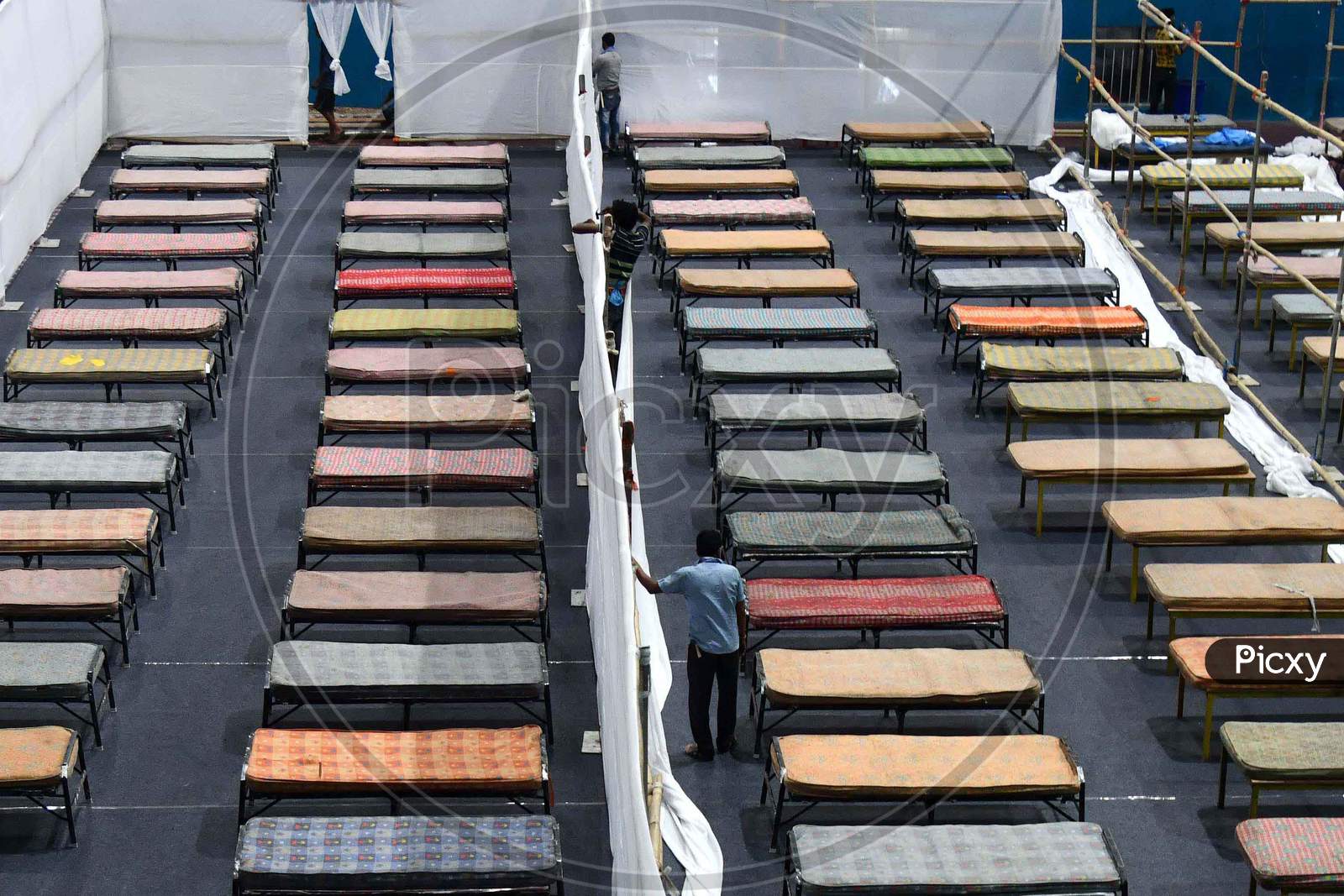 Workers  Arranges Beds To Prepare A Quarantine Centre In An Indoor Stadium At The Sarusajai Sports Complex During A Government-Imposed Nationwide Lockdown As A Preventive Measure Against The Covid-19 Coronavirus In Guwahati,India