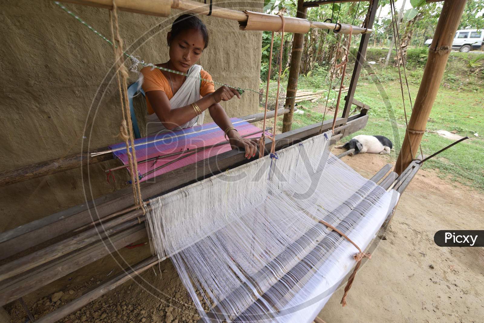 Assamese woman weaves cloth on a loom ahead of Rongali Bihu festival in the Morigaon district, in the northeastern state of Assam