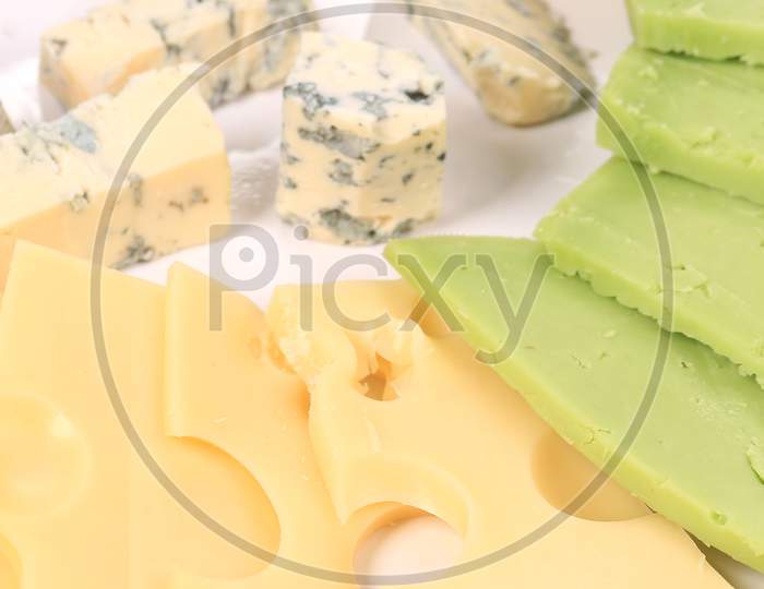 Various Types Of Cheese On Wooden Platter. Whole Background.