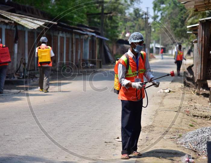A Municipality Worker Spray Disinfectant During India Government-Imposed Lockdown As A Preventive Measure Against The Covid-19 Coronavirus In Nagaon District Of Assam,India