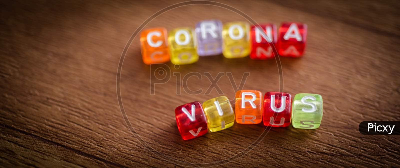 Colorful Corona Virus English Alphabet Cube On Brown Color Background , Selective Focus In Virus