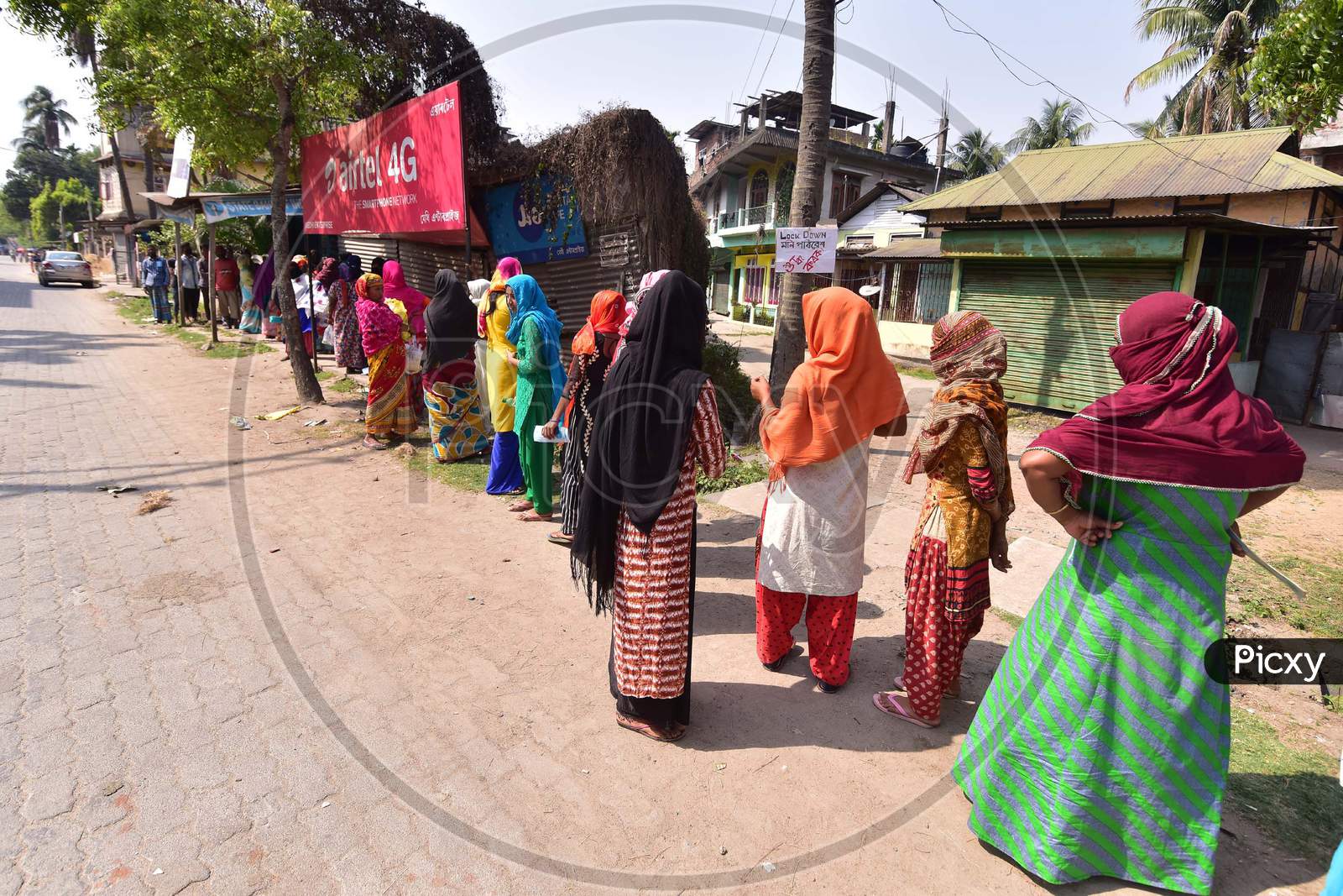 Beneficiaries Stand In A Queue Without Maintaining Social Distance In Front Of A Bank, To Receive Rs 500 Under The Pradhan Mantri Jan Dhan Yojana, During The Nationwide Lockdown Amid Coronavirus Outbreak Nagaon District Of Assam On April 06,2020.