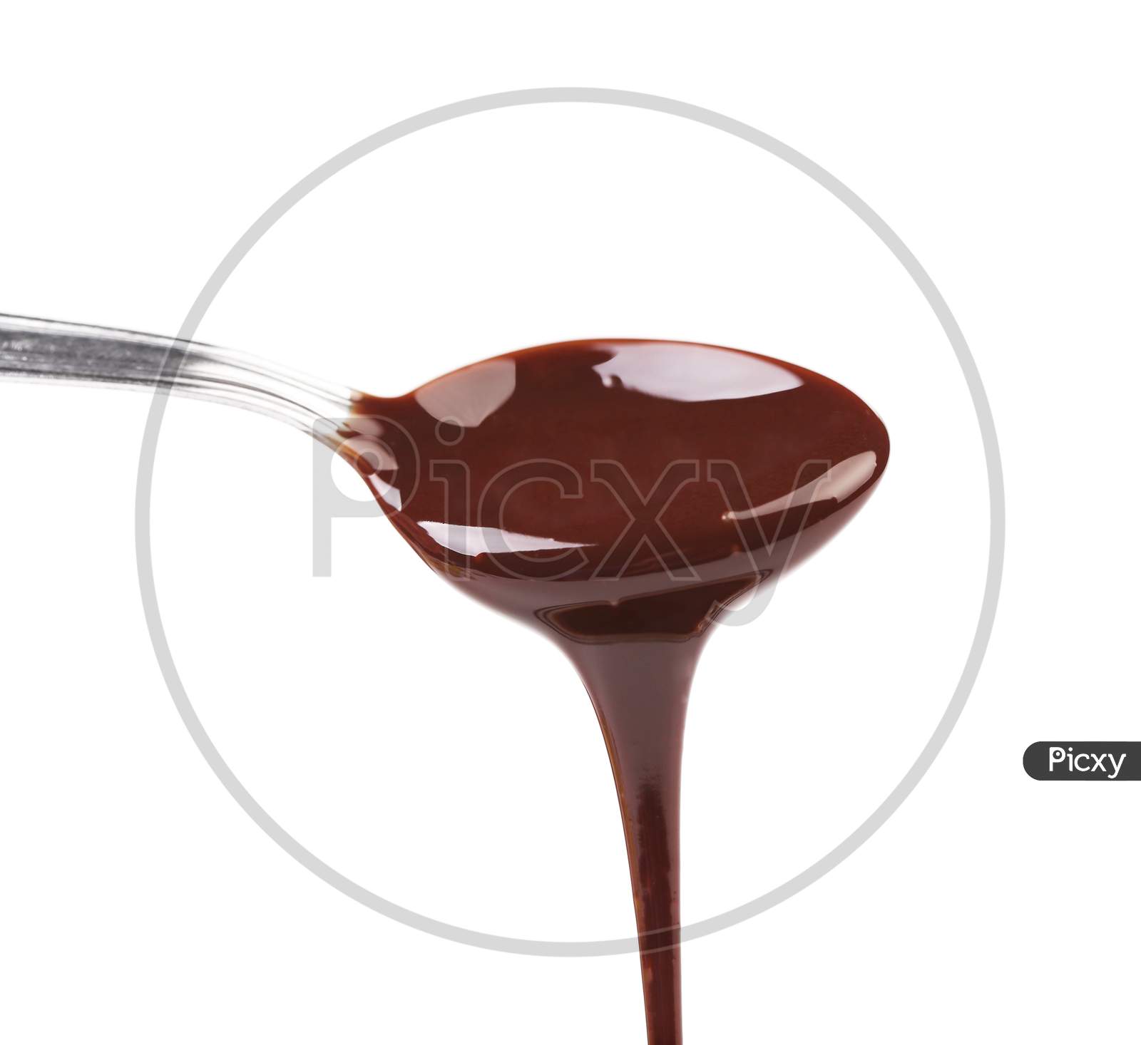 Liquid Chocolate On A Spoon. Isolated On A White Background.