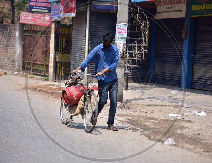 A   Commuter Carry A  L.P.G Cylender On His Bicycle  During A Nationwide Lockdown In The Wake Of Coronavirus Pandemic, In Nagaon District Of Assam ,India