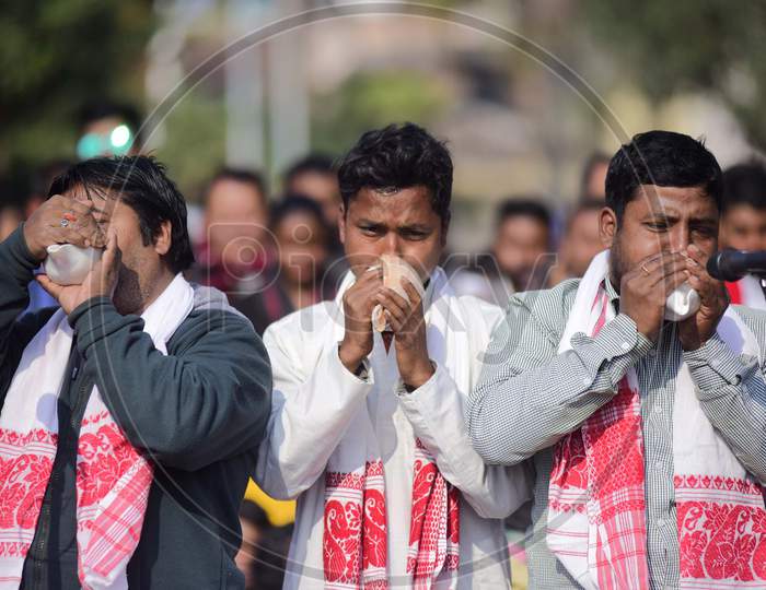 Artists play traditional musical instruments during a protest against the Citizenship Amendment Act 2019, in Guwahati