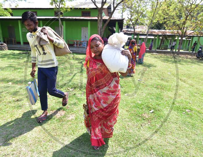 Nagaon Needy People Carry Ration After Recived From Goverment Volunteers During A Nationwide Lockdown, Imposed In The Wake Of Coronavirus Pandemic In Nagaon District Of Assam On April 04,2020