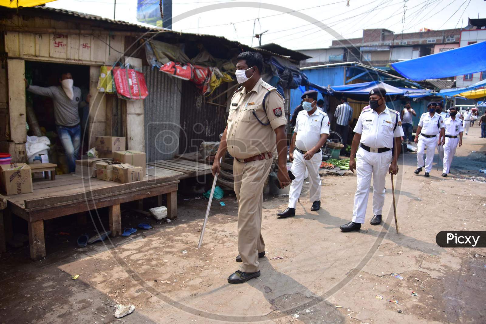 Police Personnel Patrol Through Barbazar Market Asking Vendors To Shut Their Stalls During The Third  Day Of National Lockdown Imposed By Pm Narendra Modi To Curb The Spread Of Coronavirus In Nagaon District Of Assam ,India