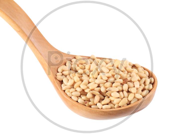 Wooden Spoon Full With Pine Nuts. Isolated On A White Background.
