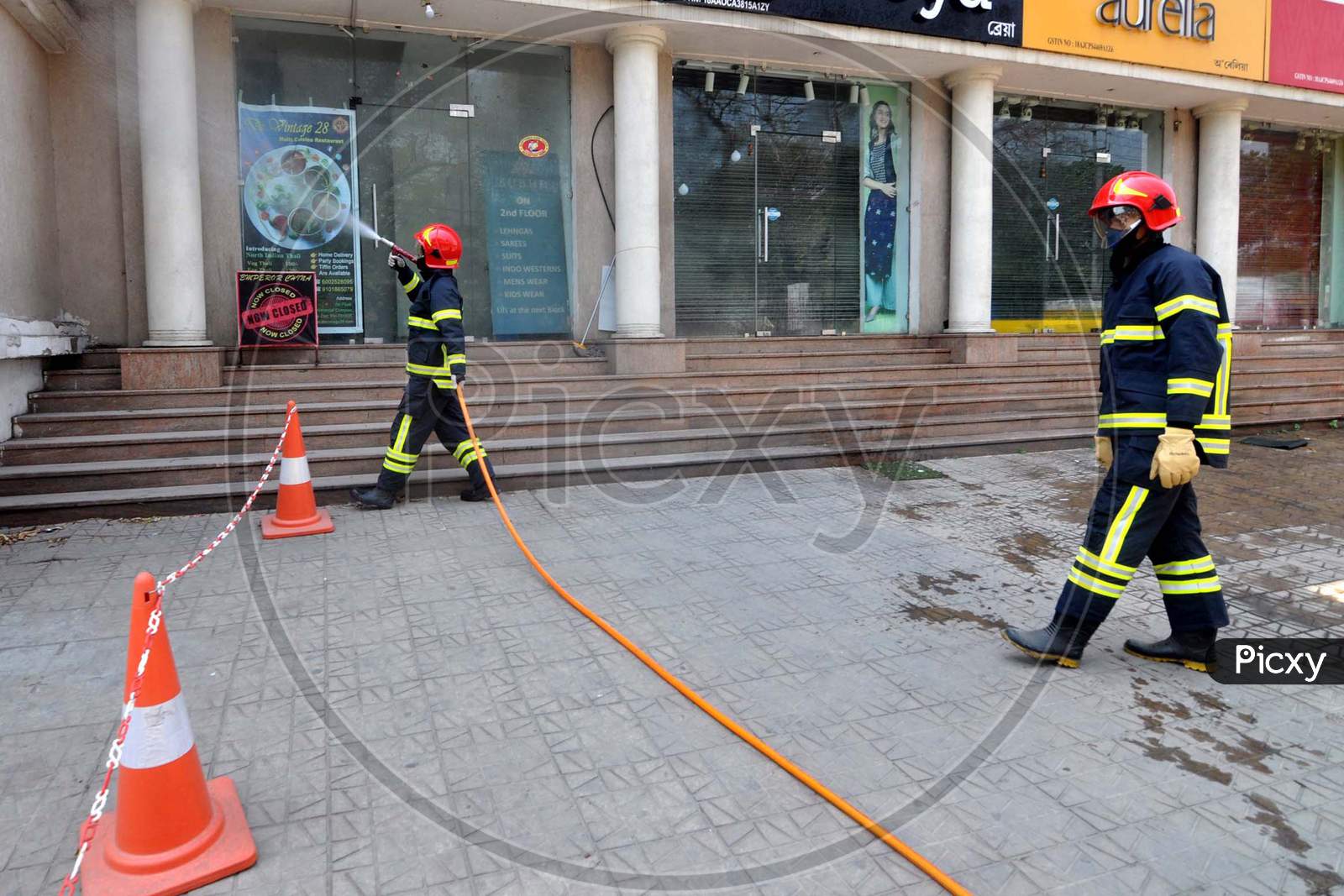 Firefighters Spray Disinfectants On Streets To Contain The Spread Of Coronavirus During The Nationwide Lockdown, In Guwahati, Saturday, April  4, 2020.