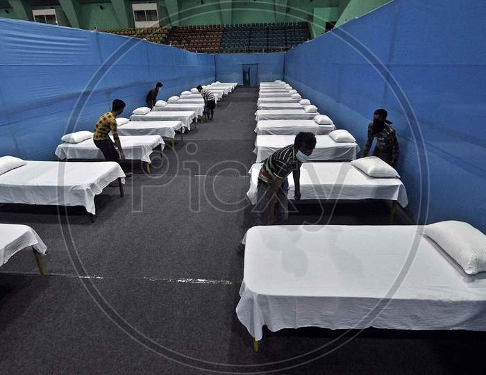 A Worker Arranges Beds To Prepare A Quarantine Centre In An Indoor Stadium At The Sarusajai Sports Complex During A Government-Imposed Nationwide Lockdown As A Preventive Measure Against The Covid-19 Coronavirus In Guwahati,India
