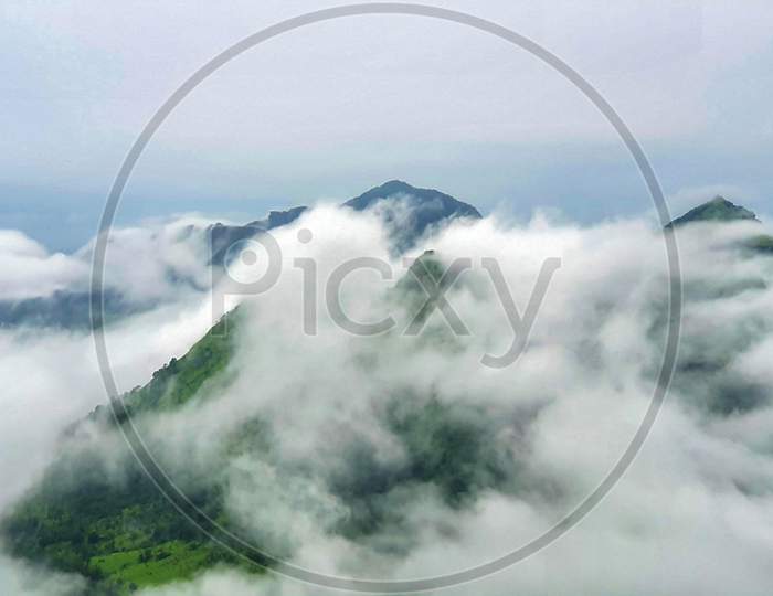 Malshej Ghat Landscape Shot With Clouds Covering Hill Top